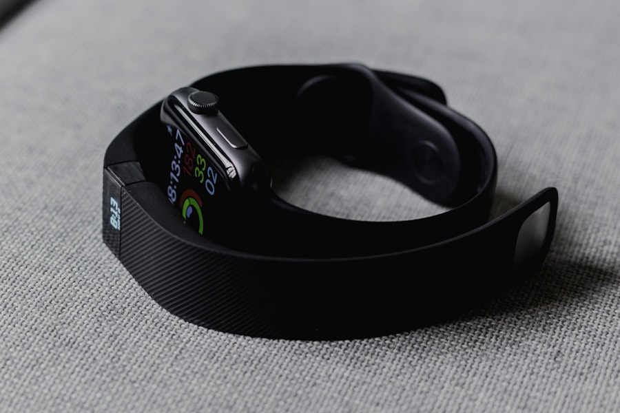 Two fitness watches showing activity rings, time, and health metrics on their displays
